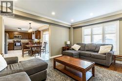 Living area with ornamental molding and recessed lighting - 