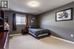 Bedroom featuring light carpet and a textured ceiling - 