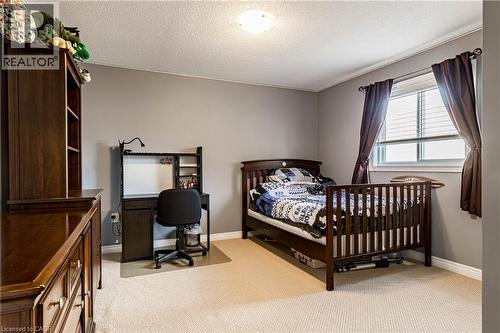 Bedroom featuring light colored carpet, a textured ceiling, and an office area - 28 Springbreeze Heights, Hamilton, ON - Indoor Photo Showing Bedroom