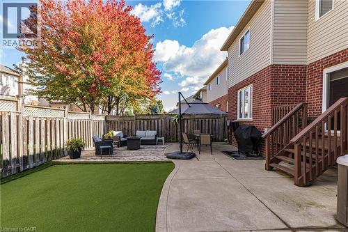 Fenced backyard with a patio area, outdoor lounge area, and grilling area - 28 Springbreeze Heights, Hamilton, ON - Outdoor With Deck Patio Veranda With Exterior