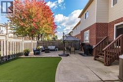 Fenced backyard with a patio area, outdoor lounge area, and grilling area - 
