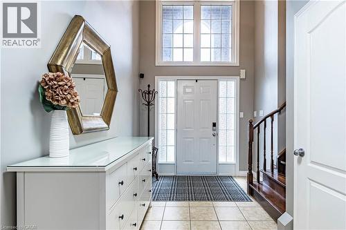 Foyer featuring healthy amount of natural light, light tile patterned floors, stairway, and a high ceiling - 28 Springbreeze Heights, Hamilton, ON - Indoor Photo Showing Other Room