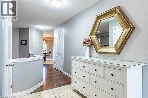 Hallway with light tile patterned floors and a textured ceiling - 28 Springbreeze Heights, Hamilton, ON - Indoor Photo Showing Other Room
