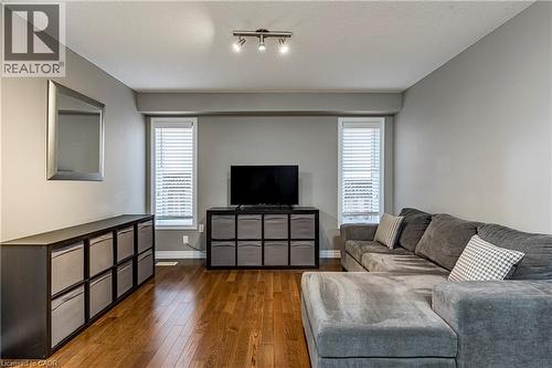 Living room with plenty of natural light, wood-type flooring, track lighting, and a textured ceiling - 28 Springbreeze Heights, Hamilton, ON - Indoor Photo Showing Living Room
