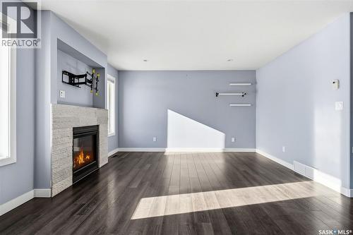 5669 Glide Crescent, Regina, SK - Indoor With Fireplace