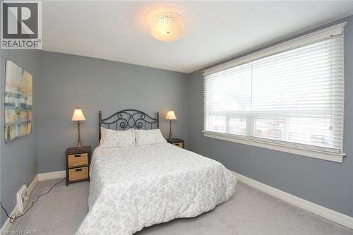 Primary Carpeted bedroom featuring baseboards - 82 Somerset Avenue, Hamilton, ON - Indoor Photo Showing Bedroom