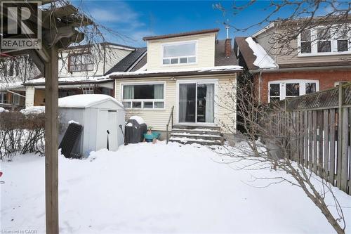 Snow covered house with a storage shed and entry steps - 82 Somerset Avenue, Hamilton, ON - Outdoor