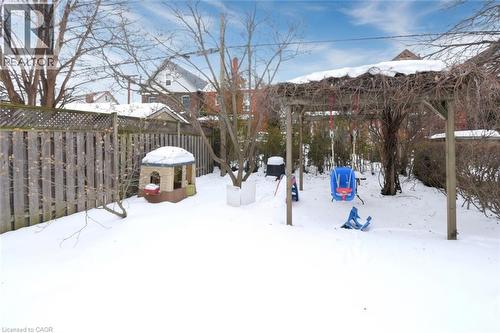 Snowy yard featuring a fenced backyard - 82 Somerset Avenue, Hamilton, ON - Outdoor