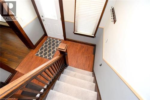 Stairway with wood finished floors - 82 Somerset Avenue, Hamilton, ON - Indoor Photo Showing Other Room