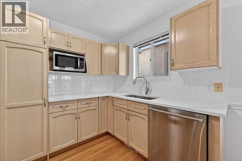 12 Sierra Morena Way Sw, Calgary, AB - Indoor Photo Showing Kitchen With Double Sink