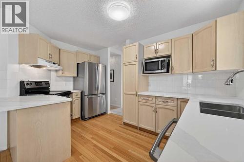 12 Sierra Morena Way Sw, Calgary, AB - Indoor Photo Showing Kitchen With Double Sink