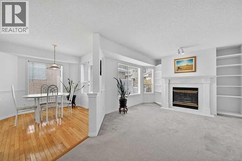 12 Sierra Morena Way Sw, Calgary, AB - Indoor Photo Showing Living Room With Fireplace