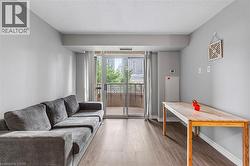 Living room featuring wood finished floors and a textured ceiling - 