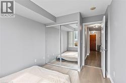 Bedroom with wood finished floors and a closet - 