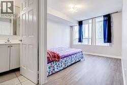 Bedroom with a textured ceiling and light wood-style floors - 