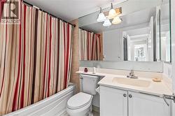 Bathroom with vanity and shower / bathtub combination with curtain - 