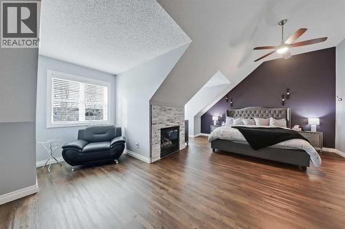 2959 Peacekeepers Way Sw, Calgary, AB - Indoor Photo Showing Bedroom With Fireplace