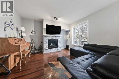 2959 Peacekeepers Way Sw, Calgary, AB - Indoor Photo Showing Living Room With Fireplace