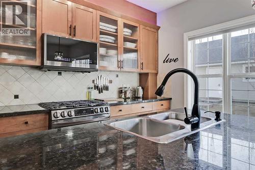 2959 Peacekeepers Way Sw, Calgary, AB - Indoor Photo Showing Kitchen With Double Sink