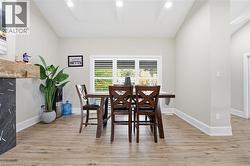 Dining space featuring light wood-style floors, recessed lighting, and lofted ceiling - 