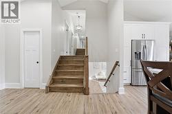 Staircase with wood finished floors and high vaulted ceiling - 