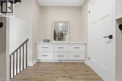 Hall featuring light wood finished floors - 