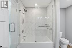 Full bathroom with enclosed tub / shower combo and toilet - 