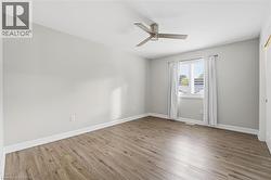 Unfurnished room with light wood finished floors and ceiling fan - 