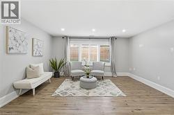 Sitting room with light wood-style flooring and recessed lighting - 
