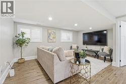 Living room featuring light wood-type flooring, recessed lighting, and healthy amount of natural light - 