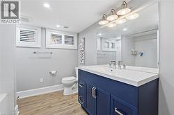 Full bath with vanity, light wood-type flooring, recessed lighting, and washtub / shower combination - 