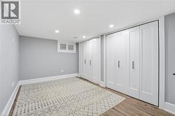 Unfurnished bedroom with multiple closets, recessed lighting, and light wood finished floors - 