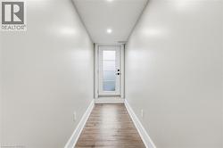 Doorway featuring wood finished floors and recessed lighting - 