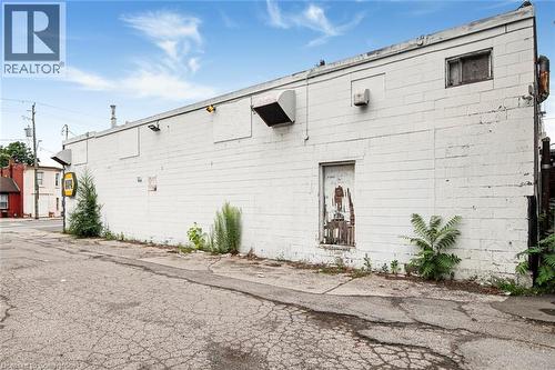 View of property exterior featuring concrete block siding - 361 Cannon Street E, Hamilton, ON 