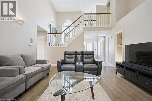 Living area featuring a high ceiling, stairway, and wood finished floors - 629 Burning Bush Road, Waterloo, ON - Indoor Photo Showing Living Room