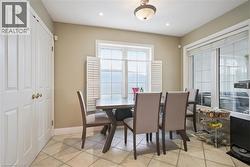Dining area featuring baseboards and light tile patterned floors - 
