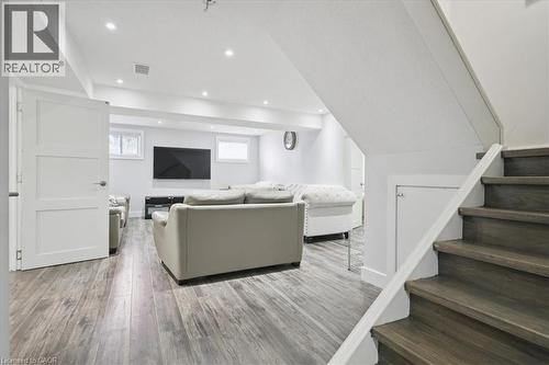 Living room with stairs, light wood finished floors, and recessed lighting - 629 Burning Bush Road, Waterloo, ON - Indoor Photo Showing Other Room