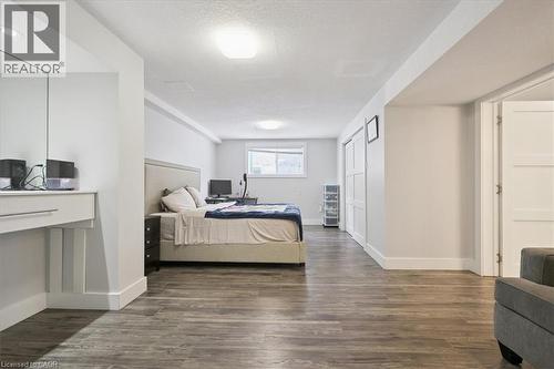 Bedroom featuring a textured ceiling and dark wood-style flooring - 629 Burning Bush Road, Waterloo, ON - Indoor Photo Showing Bedroom