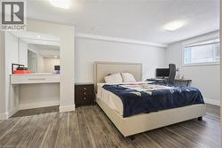 Bedroom featuring a textured ceiling and wood finished floors - 