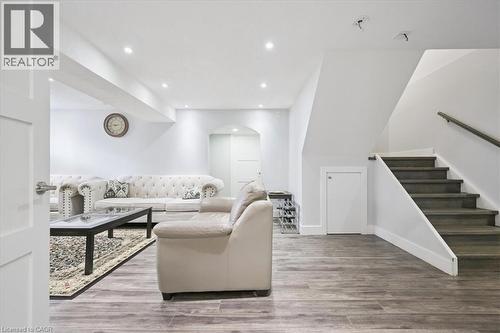 Living area with arched walkways, recessed lighting, light wood-style flooring, and stairway - 629 Burning Bush Road, Waterloo, ON - Indoor