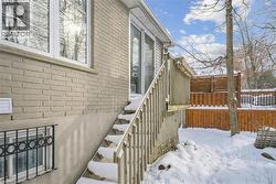 View of snow covered exterior featuring brick siding - 