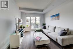 Living room featuring wood finished floors and baseboards - 