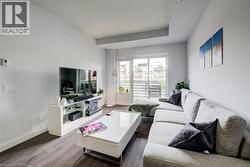 Living area with dark wood-type flooring - 