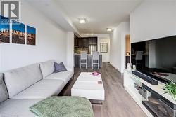 Living room featuring light wood-style flooring and baseboards - 