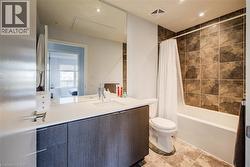 Ensuite bathroom with vanity, shower / tub combo with curtain, and recessed lighting - 