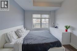 Bedroom featuring wood finished floors and baseboards - 