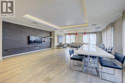 Dining space featuring light wood-type flooring, a tray ceiling, and recessed lighting - 
