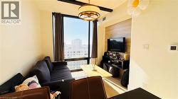 Living area featuring light wood-style floors - 