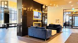 Community lobby with floor to ceiling windows and recessed lighting - 