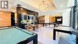 Rec room with billiards, recessed lighting, wooden walls, a chandelier, and a multi sided fireplace - 